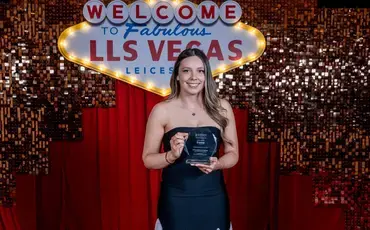 Emma holding her award