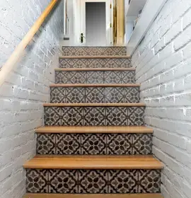 patterned stairs with white walls on side